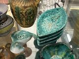 a glass table with a lot of different vases on it