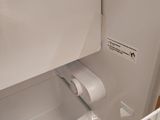an image of a refrigerator with a roll of toilet paper in it