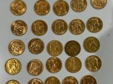 a lot of gold coins that are on the table