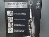 La boîte de l'aspirateur Bissell Pro Select est ouverte sur la table.