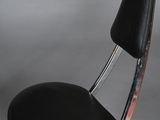 a black chair with a chrome frame and a black seat