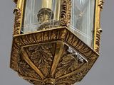 a gold lantern hanging from the side of a building
