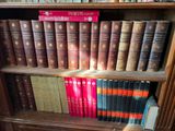 many books that are on a book shelf in the library