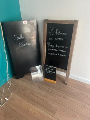 two chalk boards that are next to each other on the floor