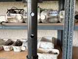 a metal pole that is in a room with lots of tools