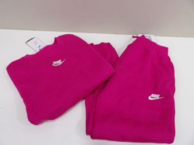 pink nike sweat pants and t - shirt are on a white table