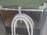 a machine with a hose attached to it in a warehouse