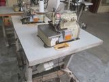 two sewing machines sitting on a table in a room