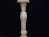 an image of a white candle holder on a black background