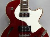 a close up of a red electric guitar on a white background