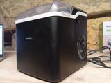 an image of a cooler sitting on top of a wooden table