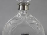 an image of a glass bottle of perfume on a table