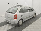 a picture of a small white car parked in a garage