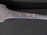 a knife and a fork on a black surface