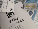 a label on a blue and white shirt with a tag on it