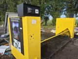 a yellow machine that is sitting on the side of the road