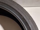 a close up of a tire on the side of a white wall