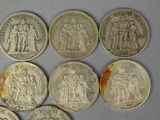 six different types of silver coins are shown on a white surface
