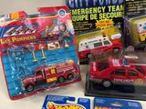 a lot of toy vehicles and books on the table