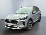 Une Ford Escape grise de 2020 est garée dans une pièce blanche