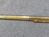 a close up of a pen laying on top of a table