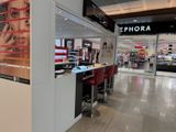 a picture of a store with red chairs in it