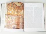 an open book with a picture of a painting on it
