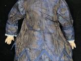 an image of a doll with blonde hair and a blue dress