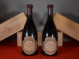 two bottles of wine sitting next to each other on a table