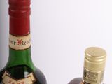 two bottles of liquor sitting next to each other on a table