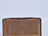 an old radio sitting on top of a table next to a charger