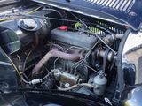 a close up of an old car engine with the hood open