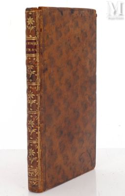 an old book sitting on top of a table next to a white wall