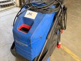 a blue and black machine sitting on top of a cement floor