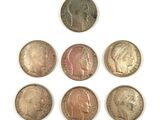 six different types of coins on a white surface
