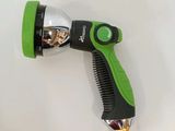 a green and black spray gun on a white surface