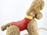 a brown teddy bear with a red shirt on a white background