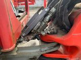 a close up of a red truck with a hose attached to the front of it