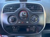 a car dashboard with a radio and a remote control