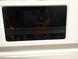 someone is taking a picture of a washing machine with their cell phone