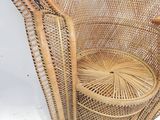 an image of a wicker chair with a basket on the back of it