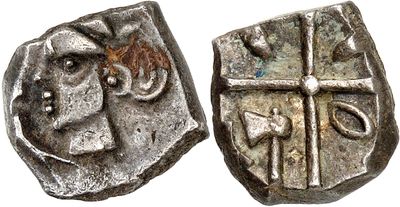 a close up of a coin with a cross on it