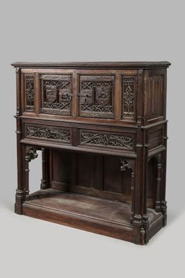 un vieux meuble en bois avec des sculptures sur le dessus et une étagère en dessous