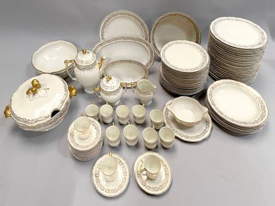 a lot of white and gold china dishes and cups