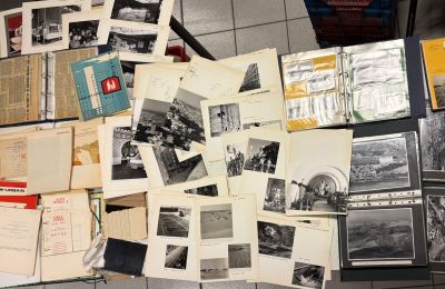 a lot of old photographs and books on the table