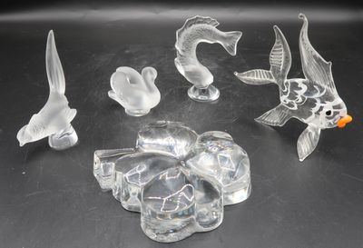 a lot of glass figurines that are sitting on a table