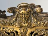 a gold vase with a lion head on top of it