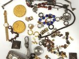 a lot of jewelry that is laying out on the table