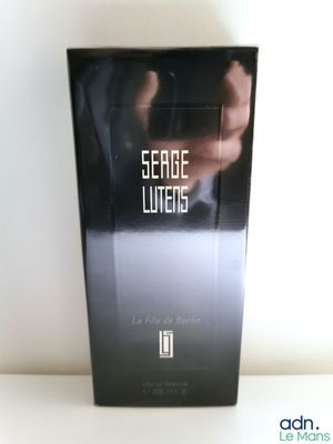 an image of a box of perfume sitting on top of a table