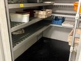 a pantry with many shelves and bins of food